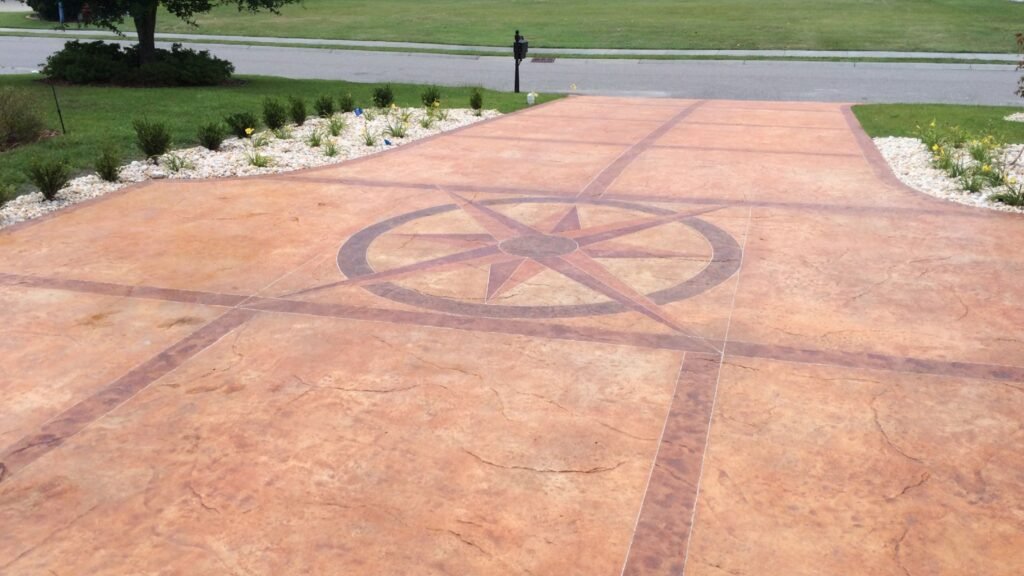 A concrete driveway with a compass rose design.