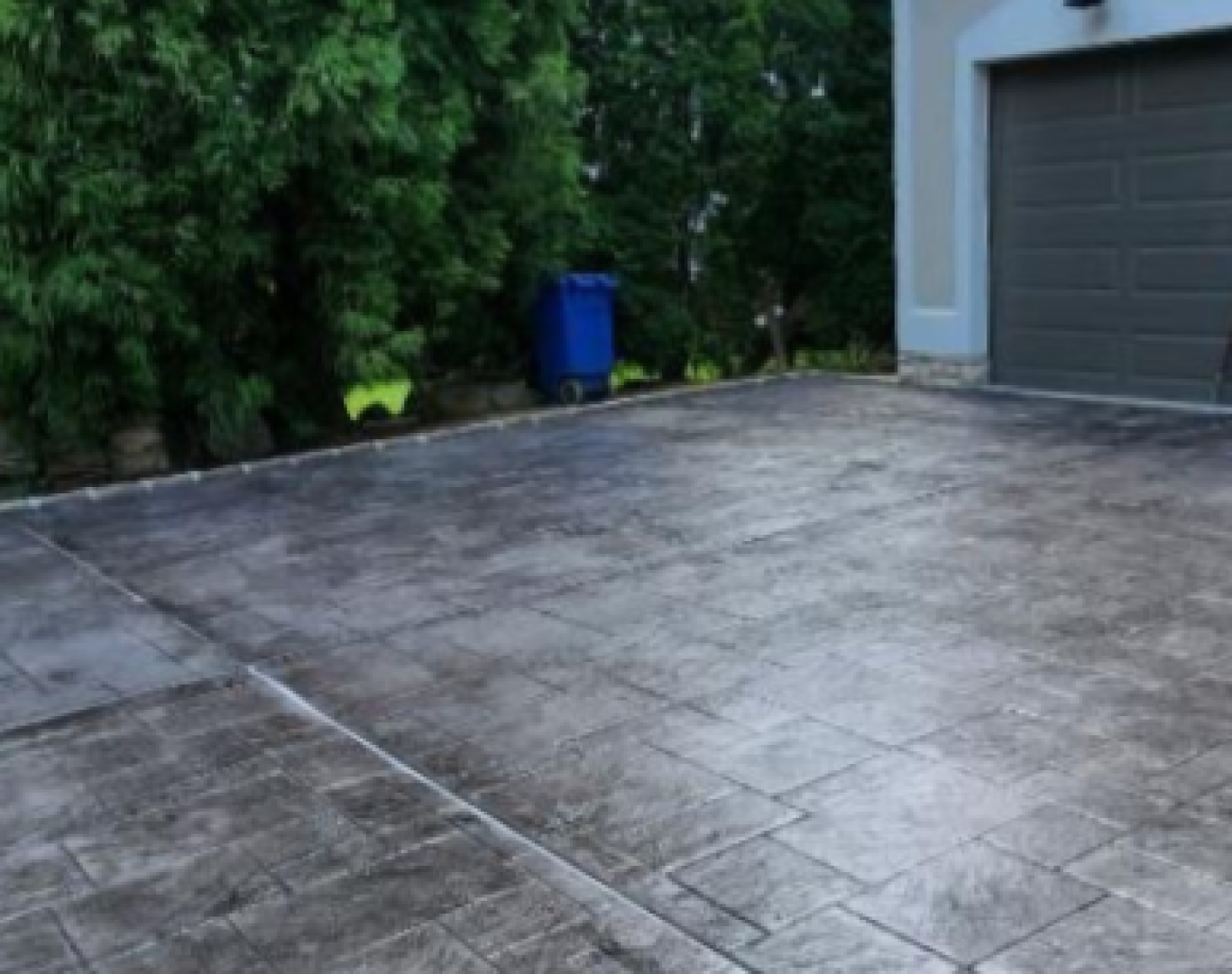 Residential decorative concrete driveway with stamped rectangular stone pattern