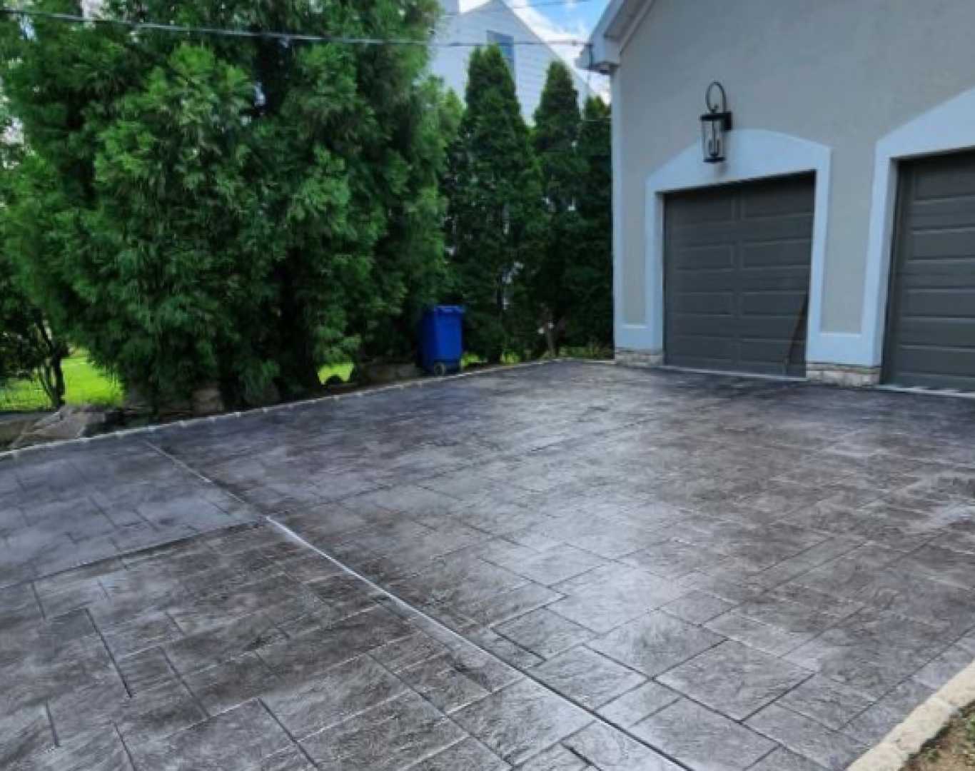 Residential decorative concrete driveway with stamped rectangular stone pattern